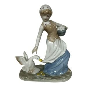 1980 Enesco Fine Porcelain Lady Carrying Eggs with Goose Tugging at Dress‎